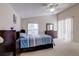 Main bedroom with vaulted ceiling, ceiling fan, bed, and dark wood furniture at 6410 Beaver Way, Tampa, FL 33625