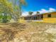 This backyard features a well-maintained lawn with a screened porch, offering a peaceful retreat in nature at 7280 Tarrytown Dr, Spring Hill, FL 34606