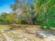 Spacious backyard with mature trees, offering plenty of shade and a peaceful setting at 7280 Tarrytown Dr, Spring Hill, FL 34606
