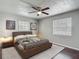 The bedroom has a large bed and two windows that provide natural light at 7280 Tarrytown Dr, Spring Hill, FL 34606