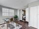 Well-lit home office featuring a glass desk, and view to bedroom, creating a comfortable and productive workspace at 7280 Tarrytown Dr, Spring Hill, FL 34606