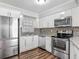 This beautifully remodeled kitchen includes stainless steel appliances, modern cabinetry and granite counters at 7280 Tarrytown Dr, Spring Hill, FL 34606