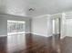 Open-concept living area with sliding glass doors that lead to the screened-in lanai at 7280 Tarrytown Dr, Spring Hill, FL 34606