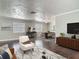 Cozy living room featuring modern decor, dark wood floors, and ample natural light from large windows at 7280 Tarrytown Dr, Spring Hill, FL 34606