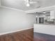 Open living area with hardwood floors that connects seamlessly with the kitchen and breakfast bar at 7280 Tarrytown Dr, Spring Hill, FL 34606