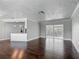 Spacious living room offering a view of the dining and kitchen areas, and sunroom through sliding doors at 7280 Tarrytown Dr, Spring Hill, FL 34606