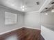 Open living area with hardwood floors and natural lighting from the windows at 7280 Tarrytown Dr, Spring Hill, FL 34606
