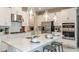 Modern kitchen features white cabinets, stainless steel appliances, an island with seating, and pendant lighting at 733 Sky Shade Dr, Apollo Beach, FL 33572