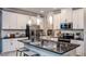Modern kitchen with black stainless steel appliances, white cabinets, and gray countertops at 733 Sky Shade Dr, Apollo Beach, FL 33572