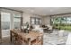 Open living and dining area with stylish decor, neutral paint, and a large window view to the backyard at 733 Sky Shade Dr, Apollo Beach, FL 33572
