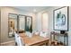 Formal dining area with neutral decor and stylish mirrors, perfect for entertaining guests at 735 Sky Shade Dr, Apollo Beach, FL 33572