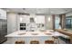 Modern kitchen with stainless steel appliances, quartz countertops, and a spacious island at 735 Sky Shade Dr, Apollo Beach, FL 33572