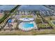 Aerial view of a community pool, playground, pickleball court, and parking area at 754 8Th Nw St, Ruskin, FL 33570