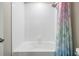 Clean white tiled bathtub and shower with colorful shower curtain, offering a bright and functional space at 754 8Th Nw St, Ruskin, FL 33570