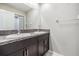 Bathroom showcasing a double sink vanity with dark cabinets and granite countertops, offering plenty of storage and style at 754 8Th Nw St, Ruskin, FL 33570