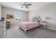 Well-lit bedroom featuring a bed with tufted headboard, neutral paint, and carpet for a cozy and inviting atmosphere at 754 8Th Nw St, Ruskin, FL 33570