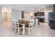 Open dining room with dark wood table and seating for eight, connected to kitchen at 754 8Th Nw St, Ruskin, FL 33570