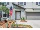 Close up of the front door of the home with an American flag, and trimmed landscaping at 754 8Th Nw St, Ruskin, FL 33570