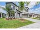 Gray two-story home with neat landscaping, two-car garage, and an American flag by the door at 754 8Th Nw St, Ruskin, FL 33570