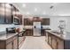 Kitchen featuring stainless steel appliances, granite counters, tile floors, and dark wood cabinets at 754 8Th Nw St, Ruskin, FL 33570