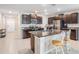 Bright kitchen featuring granite countertops, dark cabinets, and an island with a breakfast bar at 754 8Th Nw St, Ruskin, FL 33570