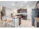 Spacious kitchen featuring granite countertops, dark cabinets, and an island with a breakfast bar at 754 8Th Nw St, Ruskin, FL 33570