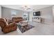 The light and airy living room offers a ceiling fan and entertainment center for storage at 754 8Th Nw St, Ruskin, FL 33570
