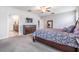 The primary bedroom provides a dresser and mirror across from the ensuite bathroom and walk-in closet at 754 8Th Nw St, Ruskin, FL 33570