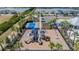 A playground with slides and other equipment sits near a pond and a tennis court at 754 8Th Nw St, Ruskin, FL 33570