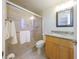 Bathroom featuring shower with glass doors, granite vanity, tile floor, and modern fixtures at 7542 20Th N St, St Petersburg, FL 33702