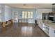 Spacious kitchen area under renovation with an island, white cabinets, stainless steel appliances, and tile flooring at 7952 1St S Ave, St Petersburg, FL 33707