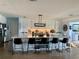 Modern kitchen featuring a large center island with seating, white cabinetry, and sleek stainless steel appliances at 7952 1St S Ave, St Petersburg, FL 33707