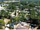 An aerial view of a property surrounded by mature trees, showcasing the home's setting within a lush, green landscape at 8054 38Th N Ave, St Petersburg, FL 33710