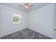 A clean bedroom with carpet, ceiling fan, and a window allowing natural light at 8054 38Th N Ave, St Petersburg, FL 33710