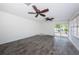 Open living room boasts two ceiling fans, wood-look tile flooring and sliding glass doors to the pool area at 8054 38Th N Ave, St Petersburg, FL 33710