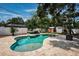Backyard featuring a kidney-shaped pool, a tiled patio area, and a play structure at 8054 38Th N Ave, St Petersburg, FL 33710