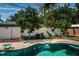 Backyard pool with lush greenery and a surrounding fence, creating a private outdoor oasis at 8054 38Th N Ave, St Petersburg, FL 33710