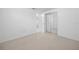 Bedroom featuring neutral carpet and a mirrored sliding-door closet at 8402 Woodlake Dr, Tampa, FL 33615