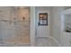 Modern bathroom featuring a glass shower with a seat, tiled floors, and window at 9118 Brunswick Ln, Tampa, FL 33615
