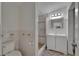 Bathroom featuring tiled walls, a walk-in shower, and a modern vanity with a lighted mirror at 9118 Brunswick Ln, Tampa, FL 33615