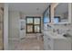 Bright bathroom with a vanity, toilet, shuttered window, and decorative accessories at 9118 Brunswick Ln, Tampa, FL 33615