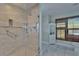 Elegant bathroom with a glass-enclosed shower, tiled floors, and storage cabinet at 9118 Brunswick Ln, Tampa, FL 33615