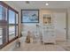 Well-lit bathroom with a toilet, vanity, shuttered window, and decorative painting at 9118 Brunswick Ln, Tampa, FL 33615