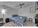 Comfortable bedroom with a blue bed, ceiling fan, stylish tile floors and a modern mini-split air conditioner at 9118 Brunswick Ln, Tampa, FL 33615