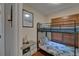 Charming bedroom with a bunk bed, decorative wall art, and nautical-themed drawers at 9118 Brunswick Ln, Tampa, FL 33615