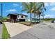 Inviting exterior showcasing a raised beach house with tropical landscaping and a convenient paved driveway, ready for coastal living at 9118 Brunswick Ln, Tampa, FL 33615