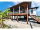 Charming raised beach house with a large screened porch and a covered area underneath, ideal for outdoor entertaining at 9118 Brunswick Ln, Tampa, FL 33615