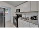 Updated kitchen featuring white cabinets, granite counters and stainless steel appliances at 9118 Brunswick Ln, Tampa, FL 33615