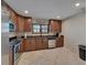 Well-lit kitchen with stainless steel appliances, granite counters, and tiled floor at 9118 Brunswick Ln, Tampa, FL 33615