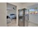 View of the kitchen and doorway into the bedroom, featuring updated appliances and tile flooring at 9118 Brunswick Ln, Tampa, FL 33615
